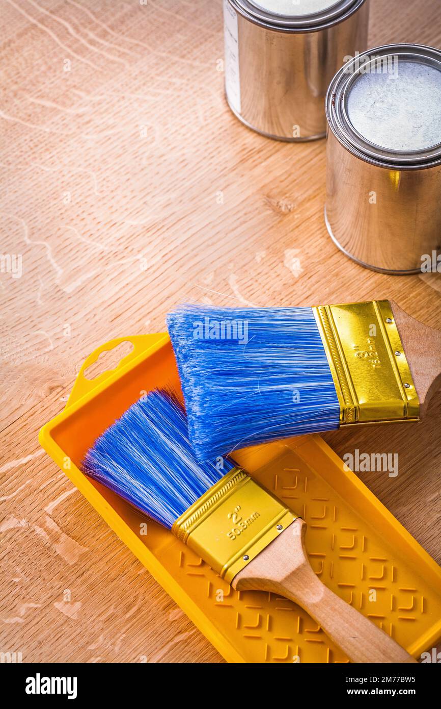 Paint brush and cans. Cans with paint and brushes on the blue