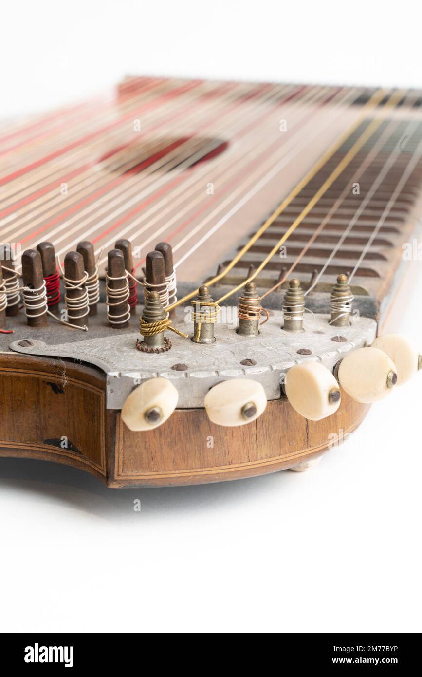 High angle vertical studio shot of vintage, old wooden zither isolated on  white background. Detail of zither mechanics and tuning pins. Dusty and  Stock Photo - Alamy