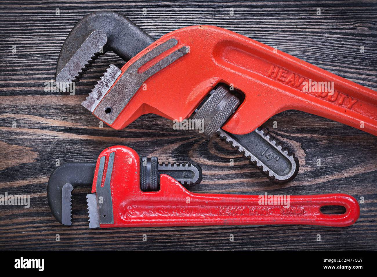 Pipe wrenches on wooden board horizontal view plumbing concept. Stock Photo