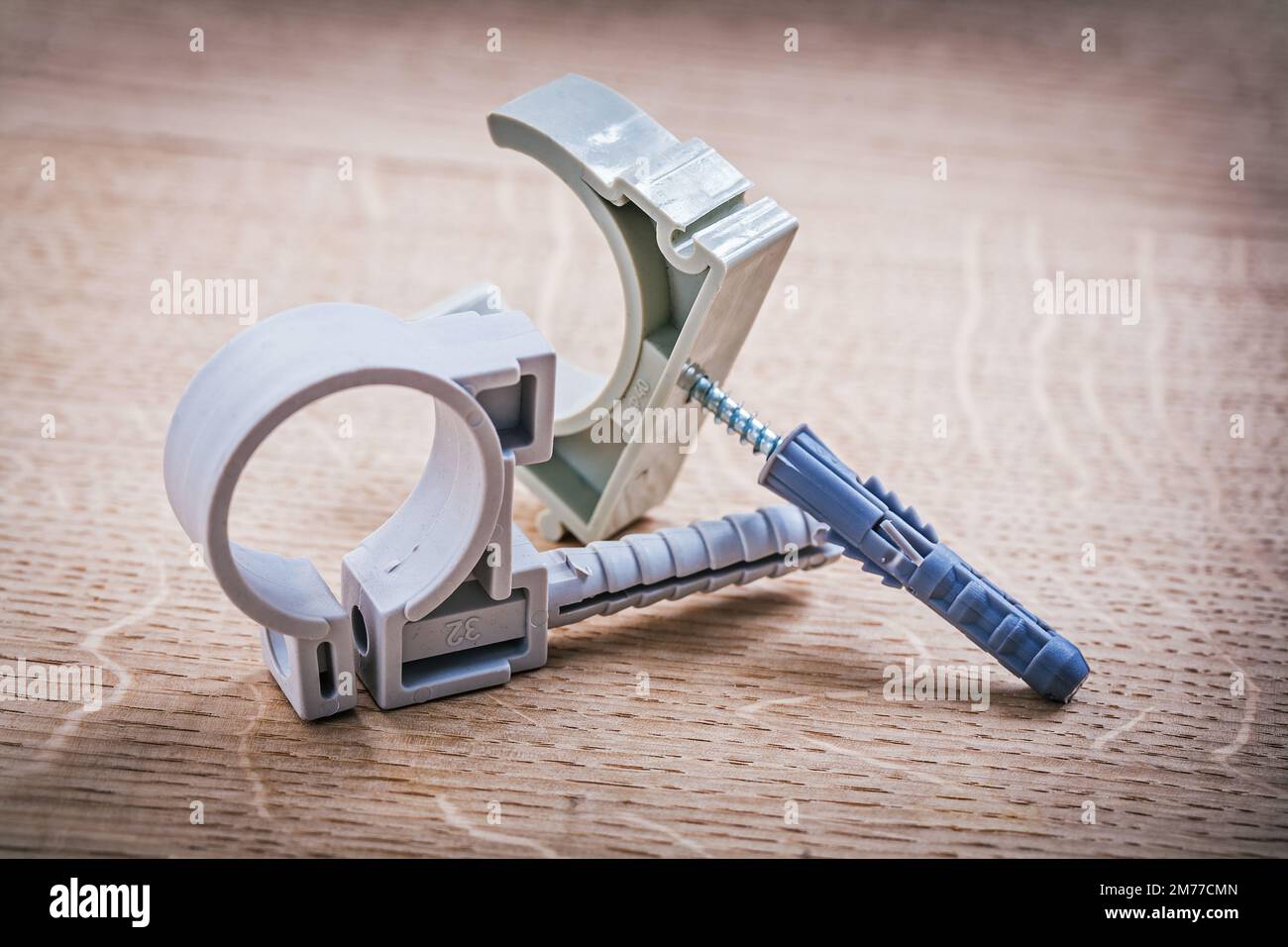 plastic fixators for pipes On Wooden Board Stock Photo