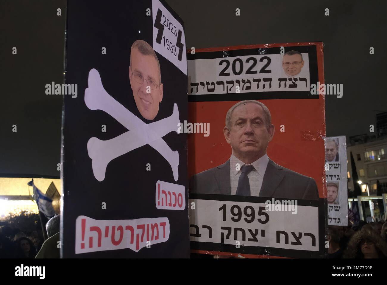 TEL AVIV, ISRAEL - JANUARY 7: A protester holds up a sign which shows Justice Minister Yariv Levin with crossbones a symbol of Nazi Germany during a demonstration against Israel's new government's judicial system plan that aims to weaken the country's Supreme Court on January 7, 2023, in Tel Aviv, Israel. Civil liberties advocates accuse the new government of declaring war against the legal system, saying the proposed plan will put minority rights in imminent danger and will endanger the country's democracy. Credit: Eddie Gerald/Alamy Live News Stock Photo