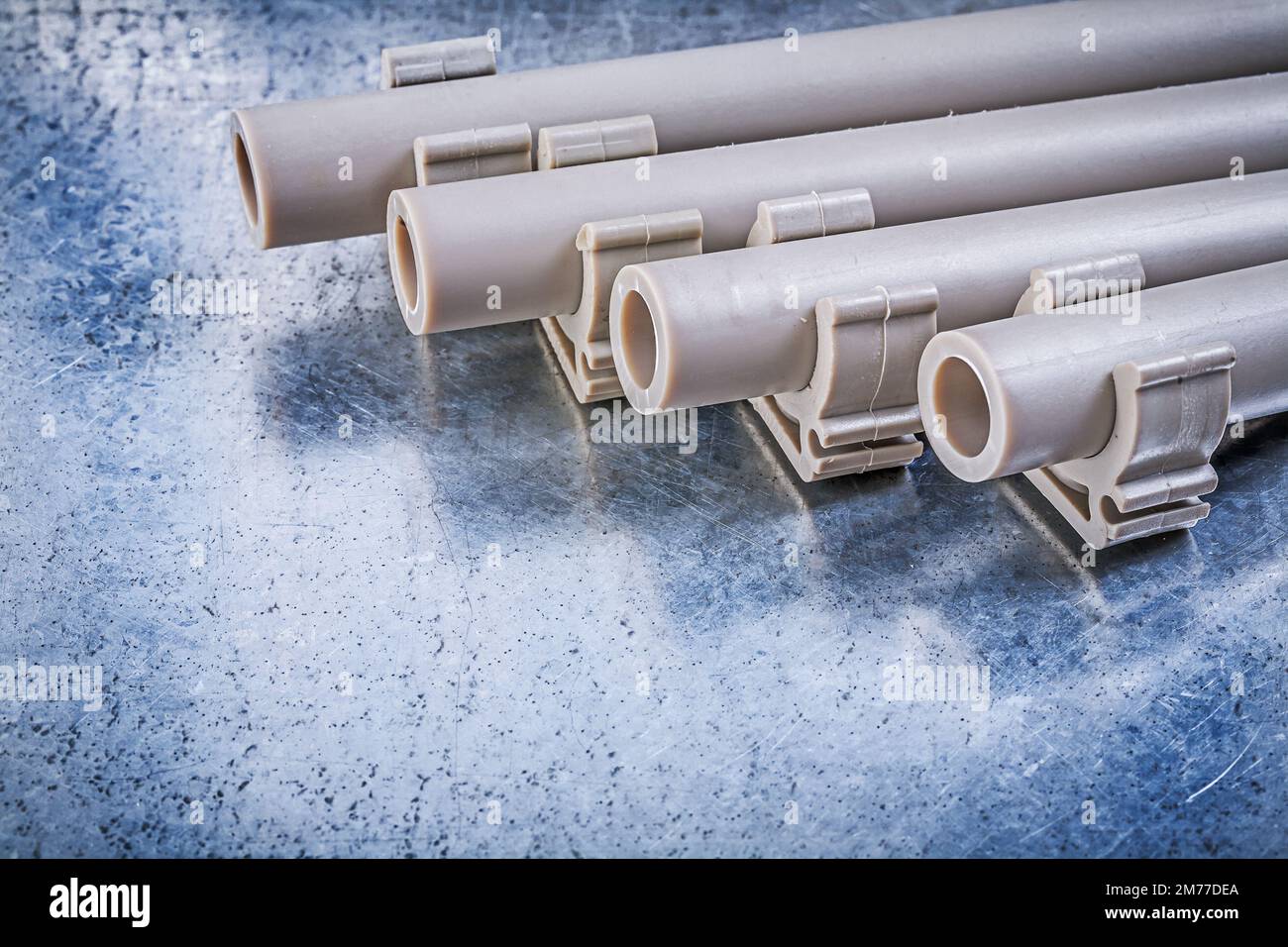 Pvc waterpipes pipe clamps on metallic background construction concept Stock Photo Alamy