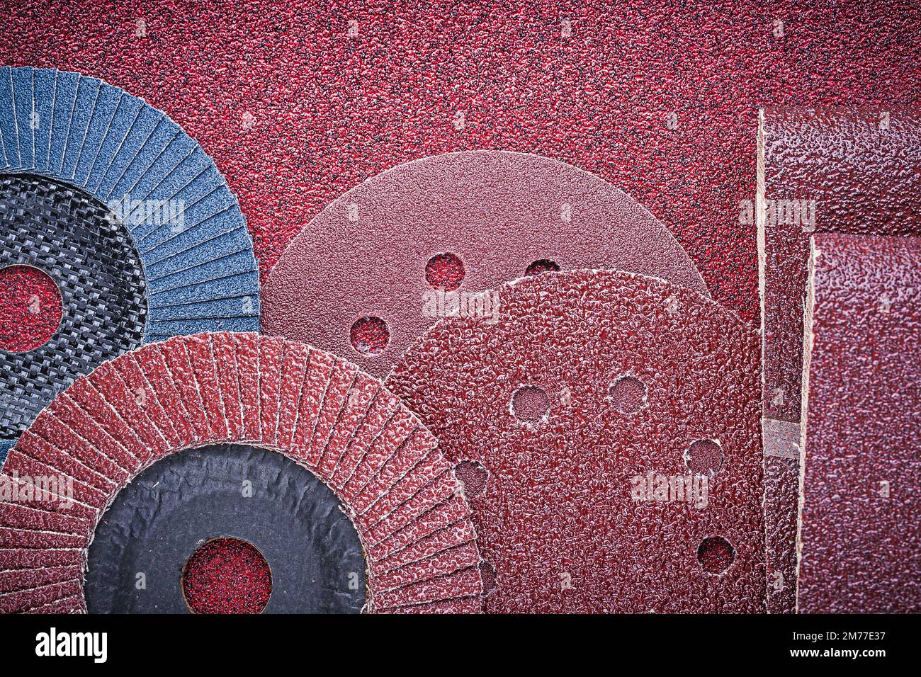 Rolled abrasive paper grinding wheels on polishing sheet Stock Photo