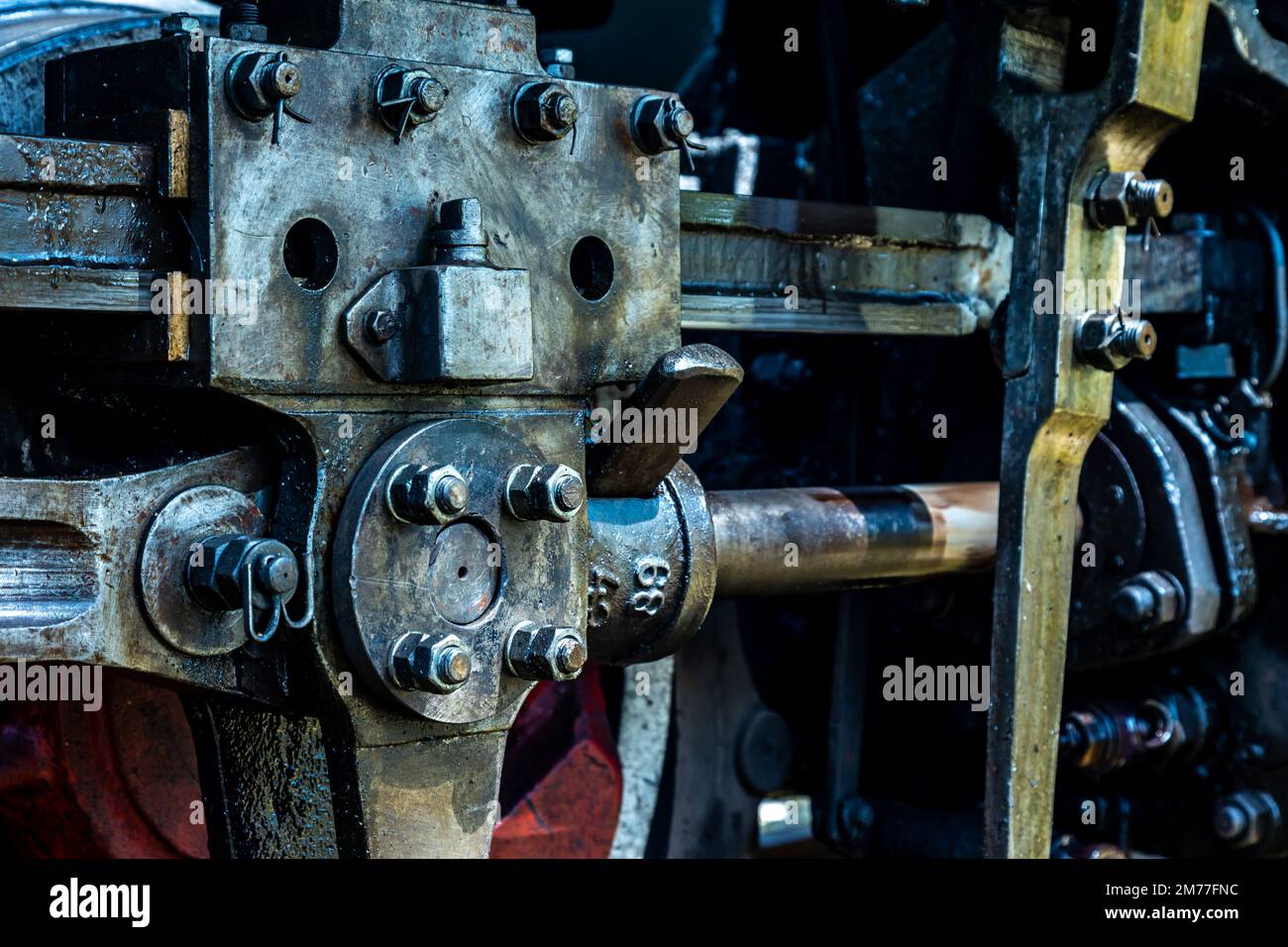 A closeup of a steam propulsion system. Steam standing on the tracks