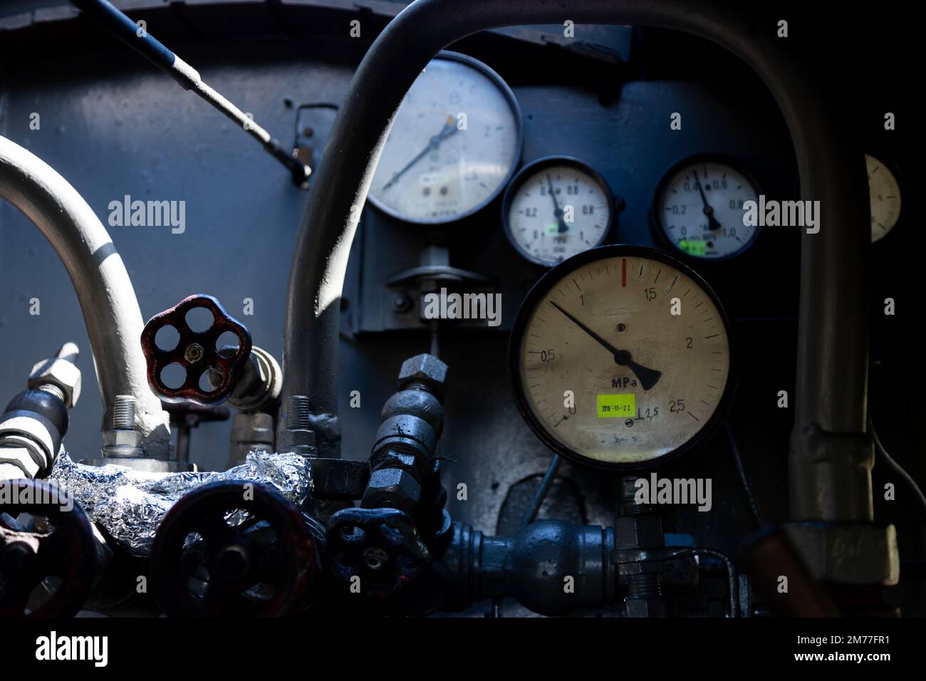 A set of pressure gauges and other gauges on a steam boiler. Interior of a steam