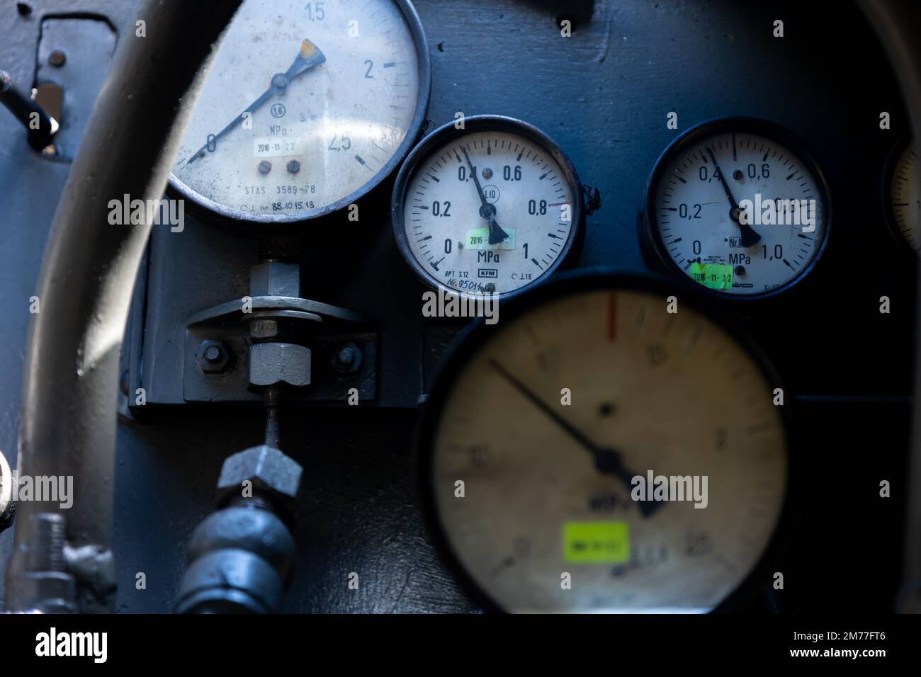 A set of pressure gauges and other gauges on a steam boiler
