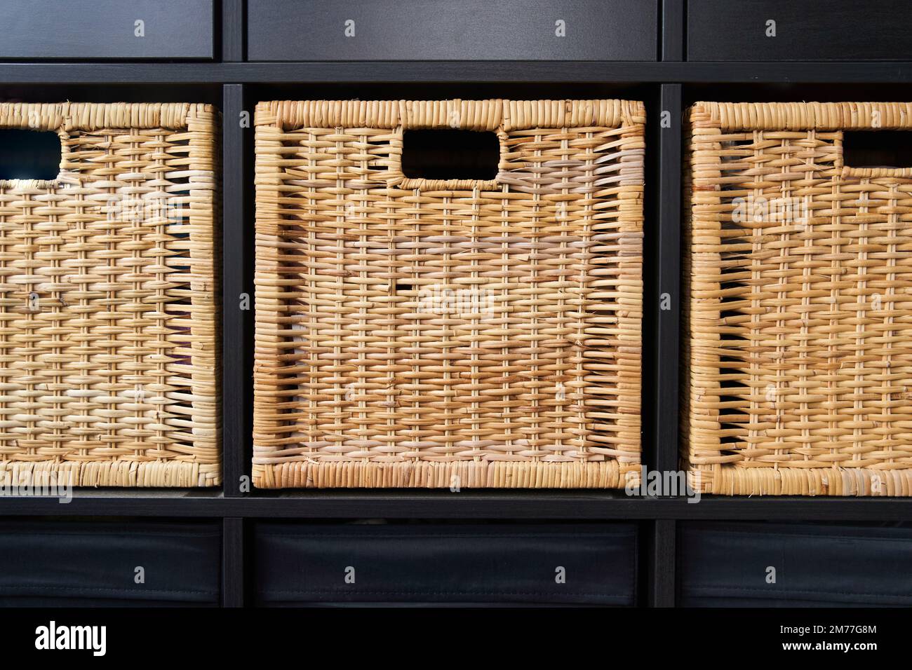 Wicker boxes for things on the shelves. Wardrobe for storage of things Stock Photo