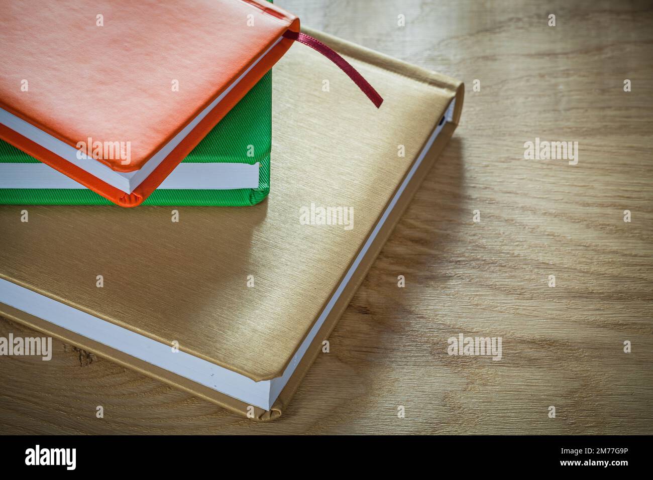 Stack of office notebooks on wooden board. Stock Photo