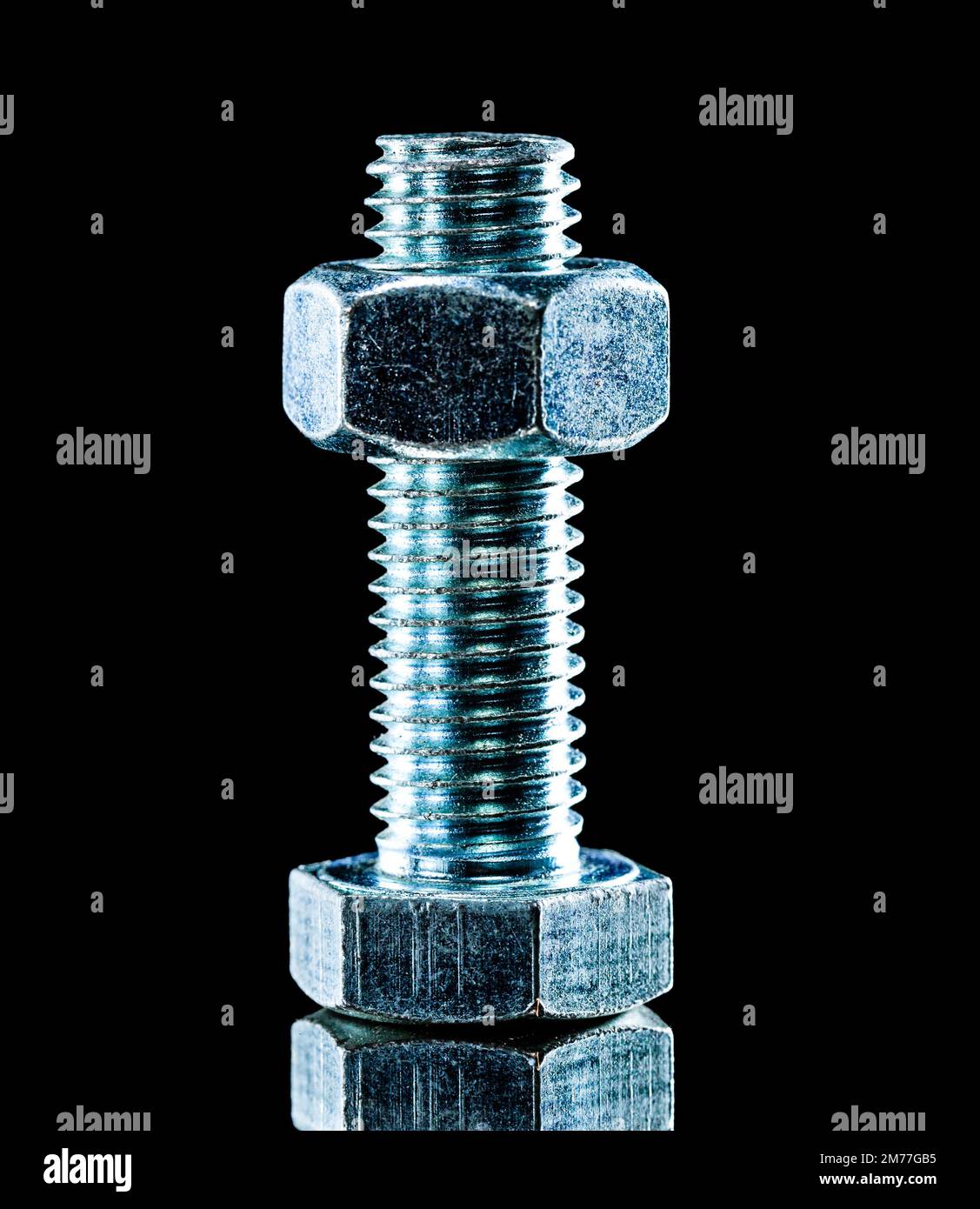 Stainless nut bolt on black surface Stock Photo Alamy