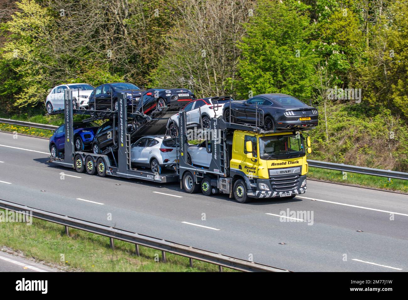 ARNOLD CLARK Car carrier. DAF Trucks 450FTP 9 vehicle car transporter, Haulage delivery trucks, collection and deliveries, lorry, transportation, cars & truck, cargo, DAF vehicle, delivery, commercial transport, industry, on the M61 at Chorley, UK Stock Photo