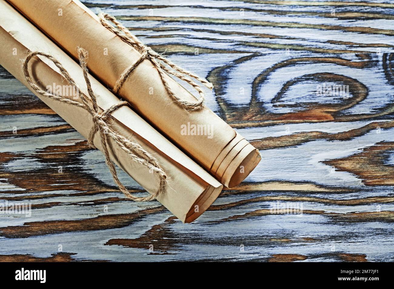 Vintage paper scrolls on wooden board Stock Photo - Alamy