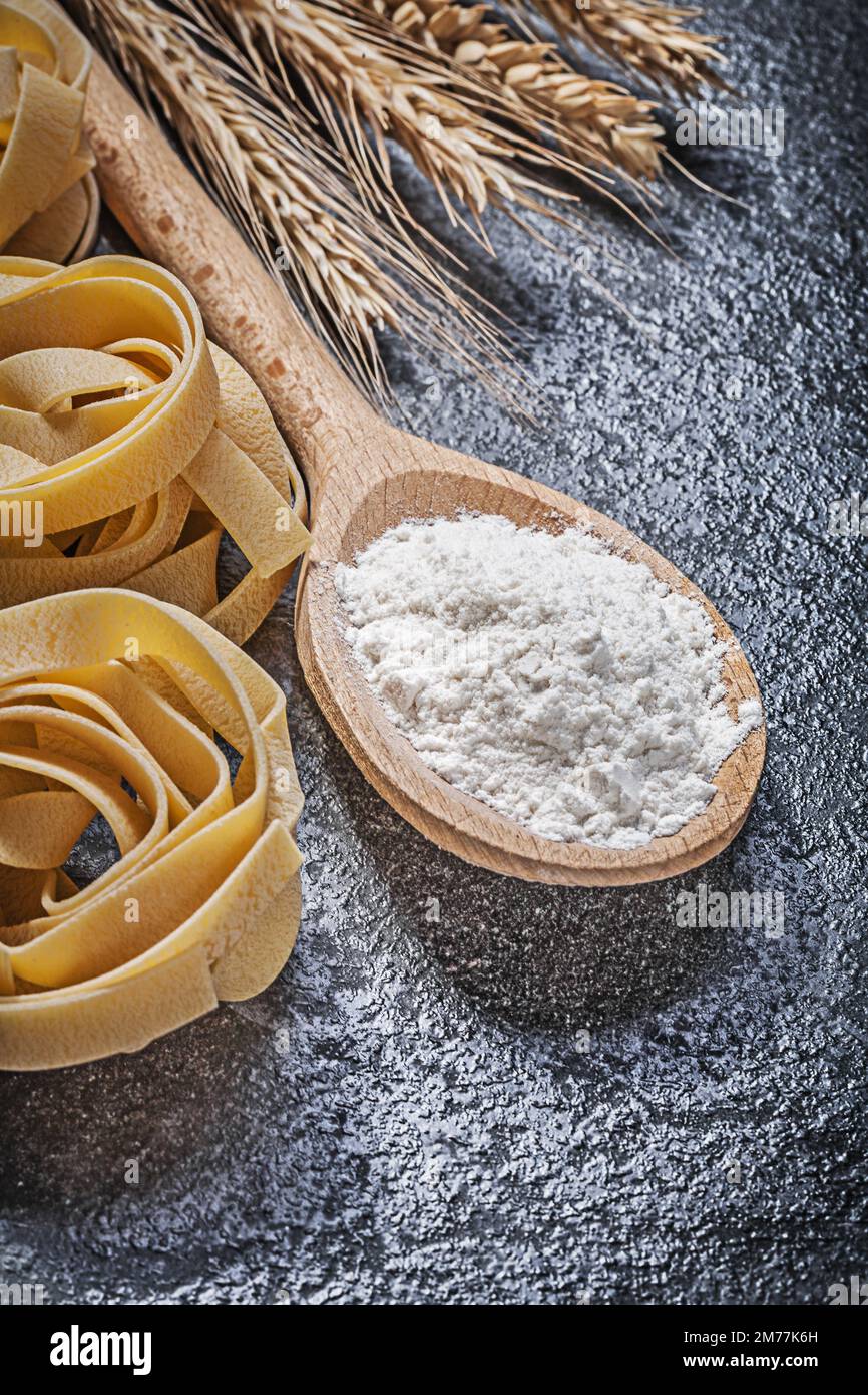 Uncooked Rye Wheat rye ears wooden spoon flour uncooked twisted macaroni on black ...
