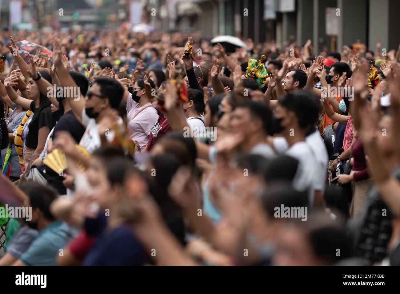Filipino Catholics wave their hands in the air and hold up Santo Nino figurines whilst the religious song Batobalani sa Gugma is being played at the B Stock Photo