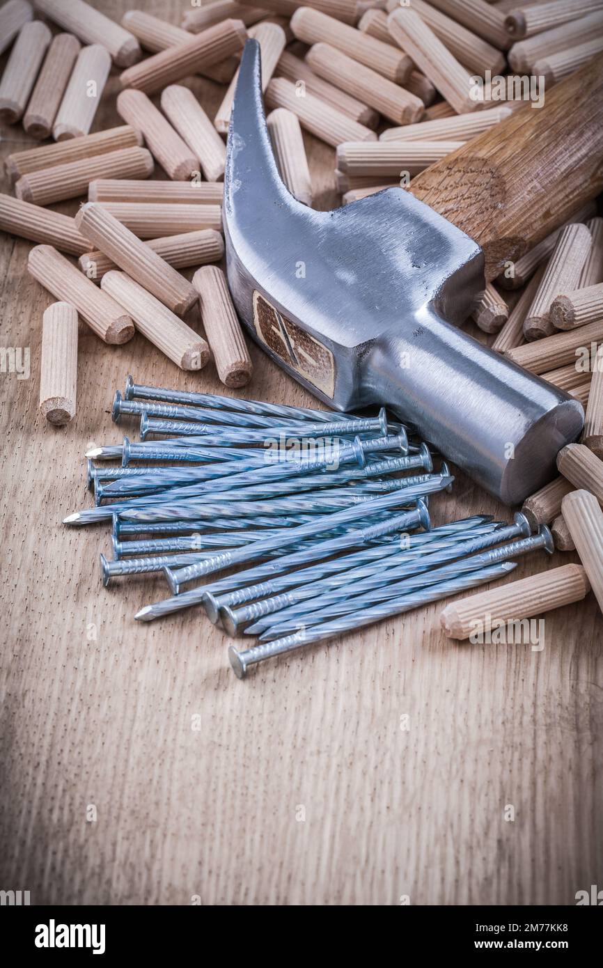 Wooden dowels steel nails and claw hammer construction concept Stock Photo Alamy