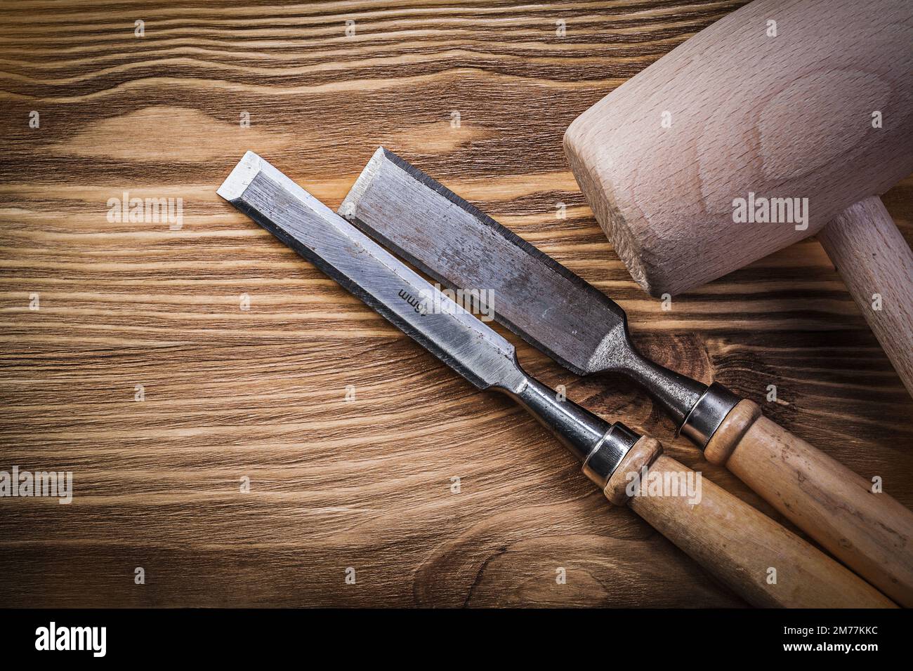 Wooden hammer chisels on vintage wood board construction concept. Stock Photo