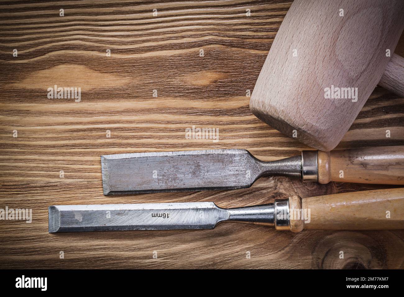 Wooden mallet chisels on vintage wood board construction concept. Stock Photo