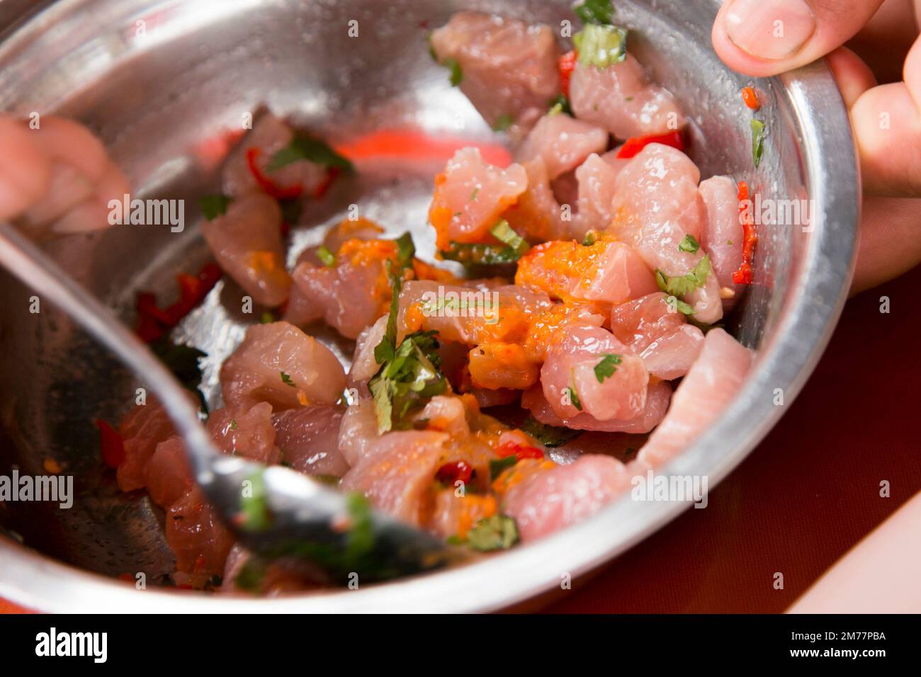 Preparing a delicious Peruvian sea bass ceviche in the fishing port of