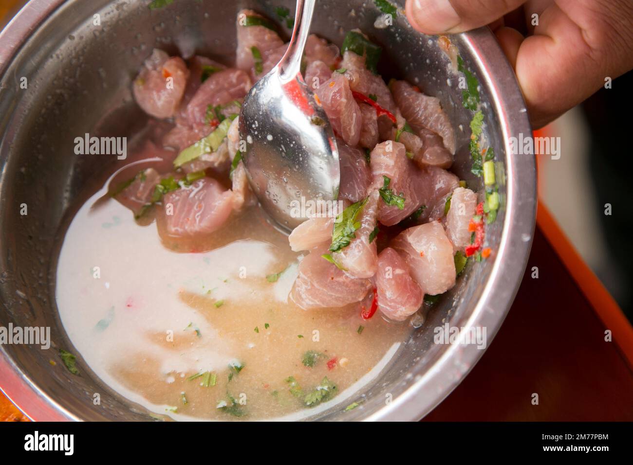 Preparing a delicious Peruvian sea bass ceviche in the fishing port of