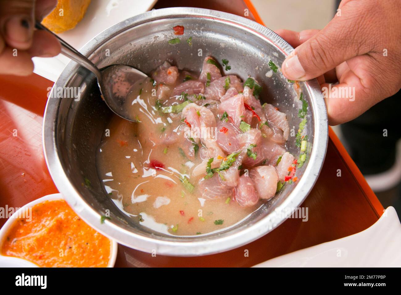 Preparing a delicious Peruvian sea bass ceviche in the fishing port of