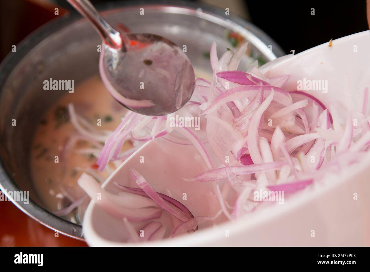 Preparing a delicious Peruvian sea bass ceviche in the fishing port of