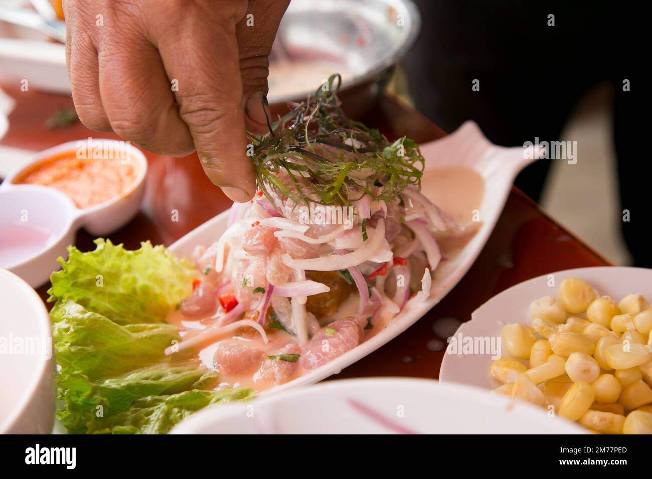 Preparing a delicious Peruvian sea bass ceviche in the fishing port of
