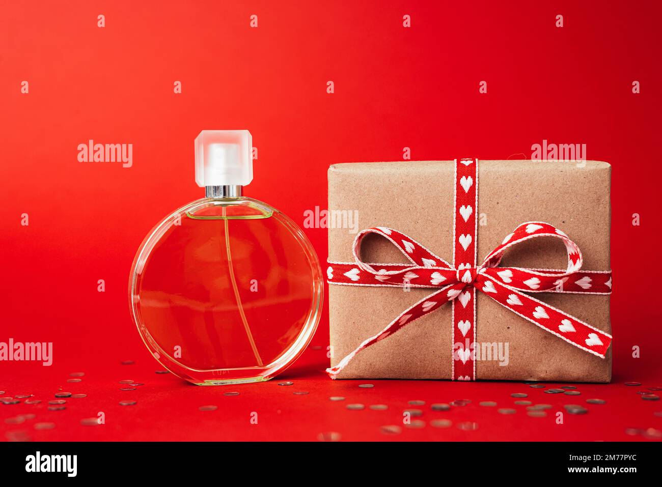 Perfume on red background. Gift on valentine's day Stock Photo