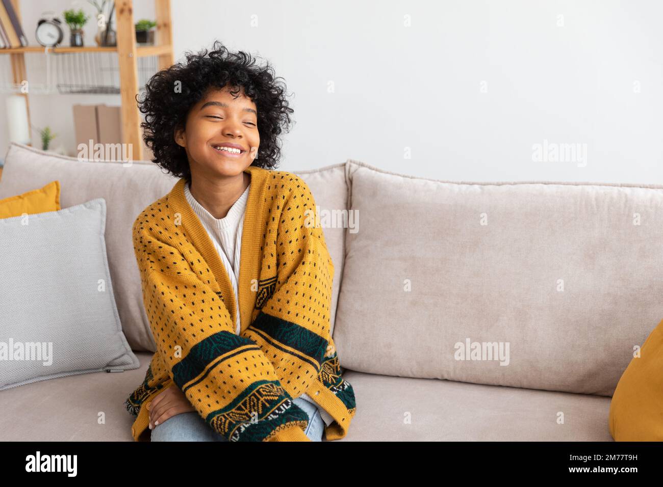 Beautiful african american girl with afro hairstyle smiling sitting on ...