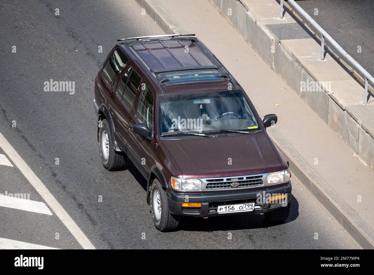 Moscow, Russia - September 27, 2022: Japanese brown and burgundy Nissan Pathfinder R50 car driving on the road (Nissan Terrano old) Stock Photo