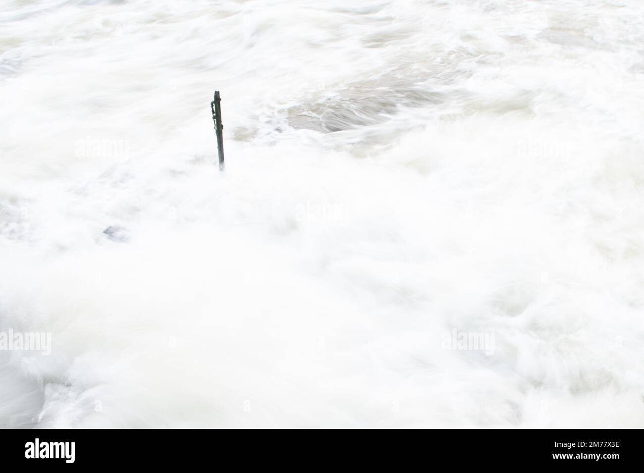 Fast flowing water over a weir Stock Photo