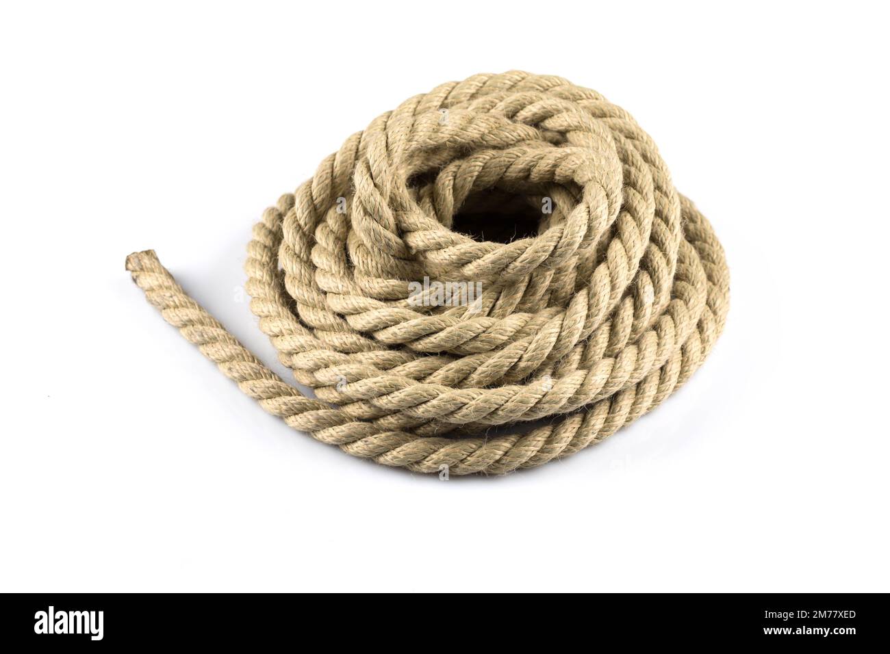 Twisted thick ship ropes with knot isolated background Stock Photo