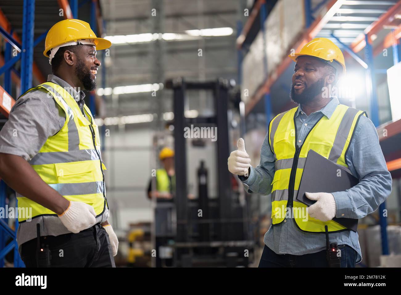 African american working in warehouse hold stock check list while truck ...