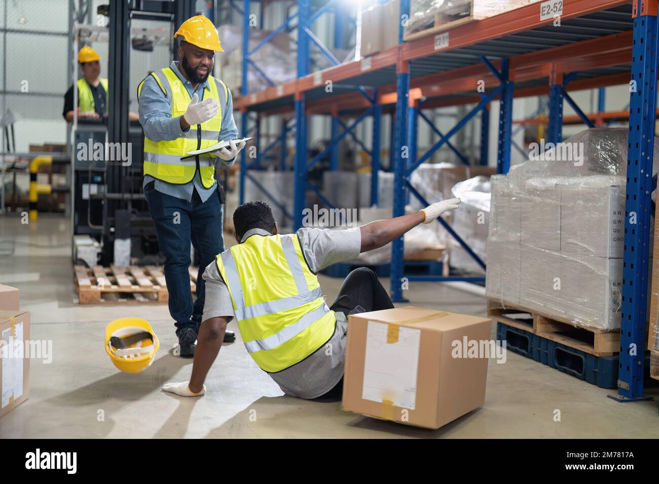 African american working in warehouse got accident from carry box