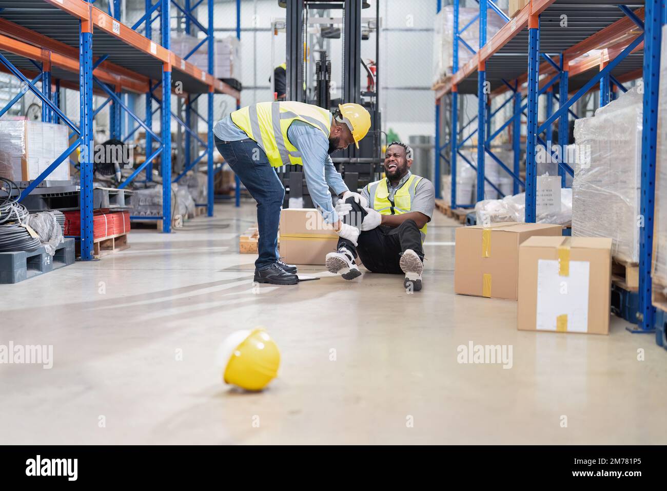 African american working in warehouse got accident from carry box