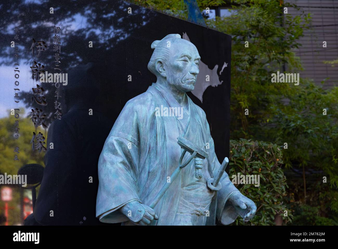 A Japanese stone statue at Tomioka Shrine with copyspace Stock Photo