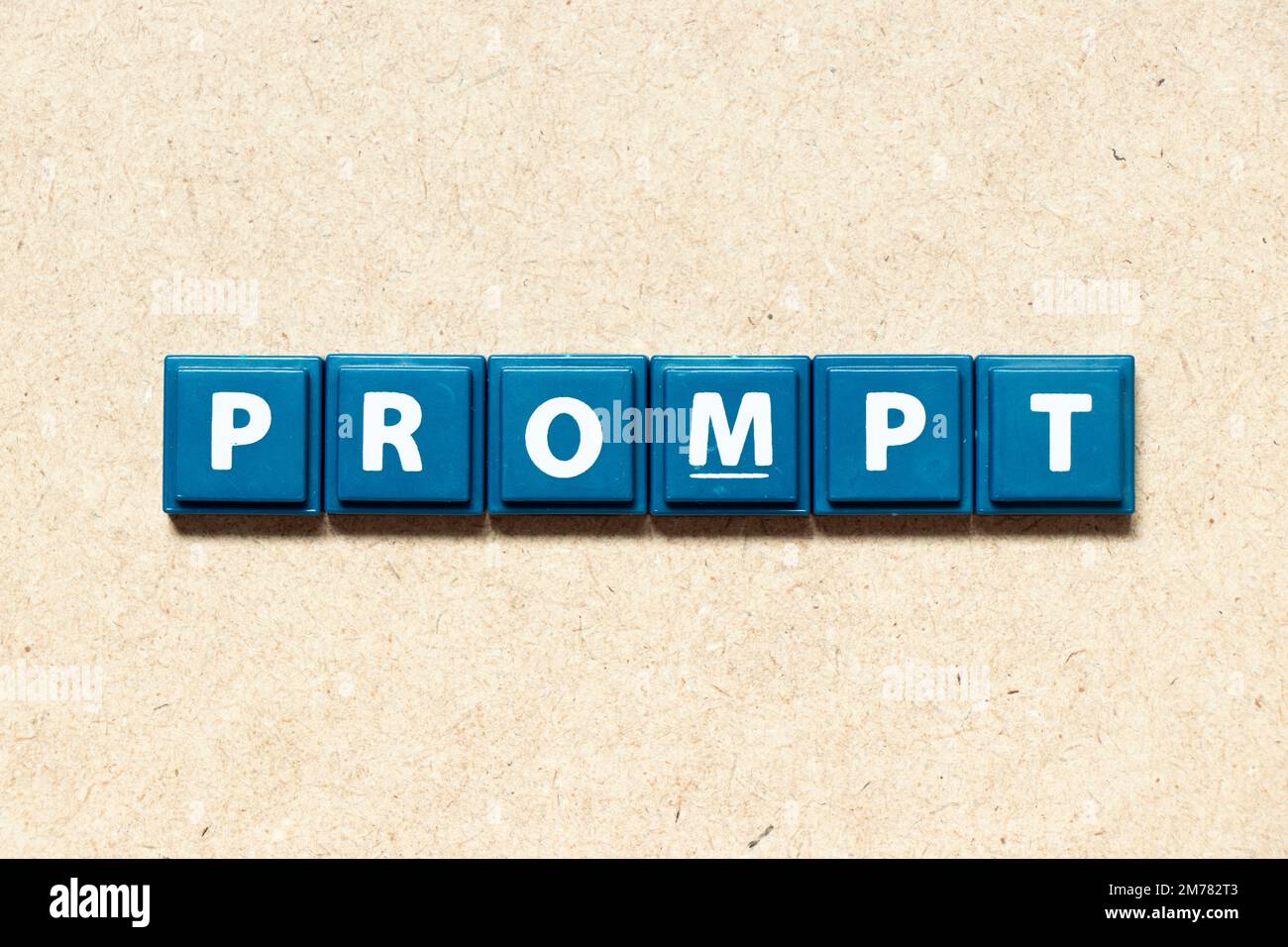 Tile alphabet letter in word prompt on wood background Stock Photo - Alamy