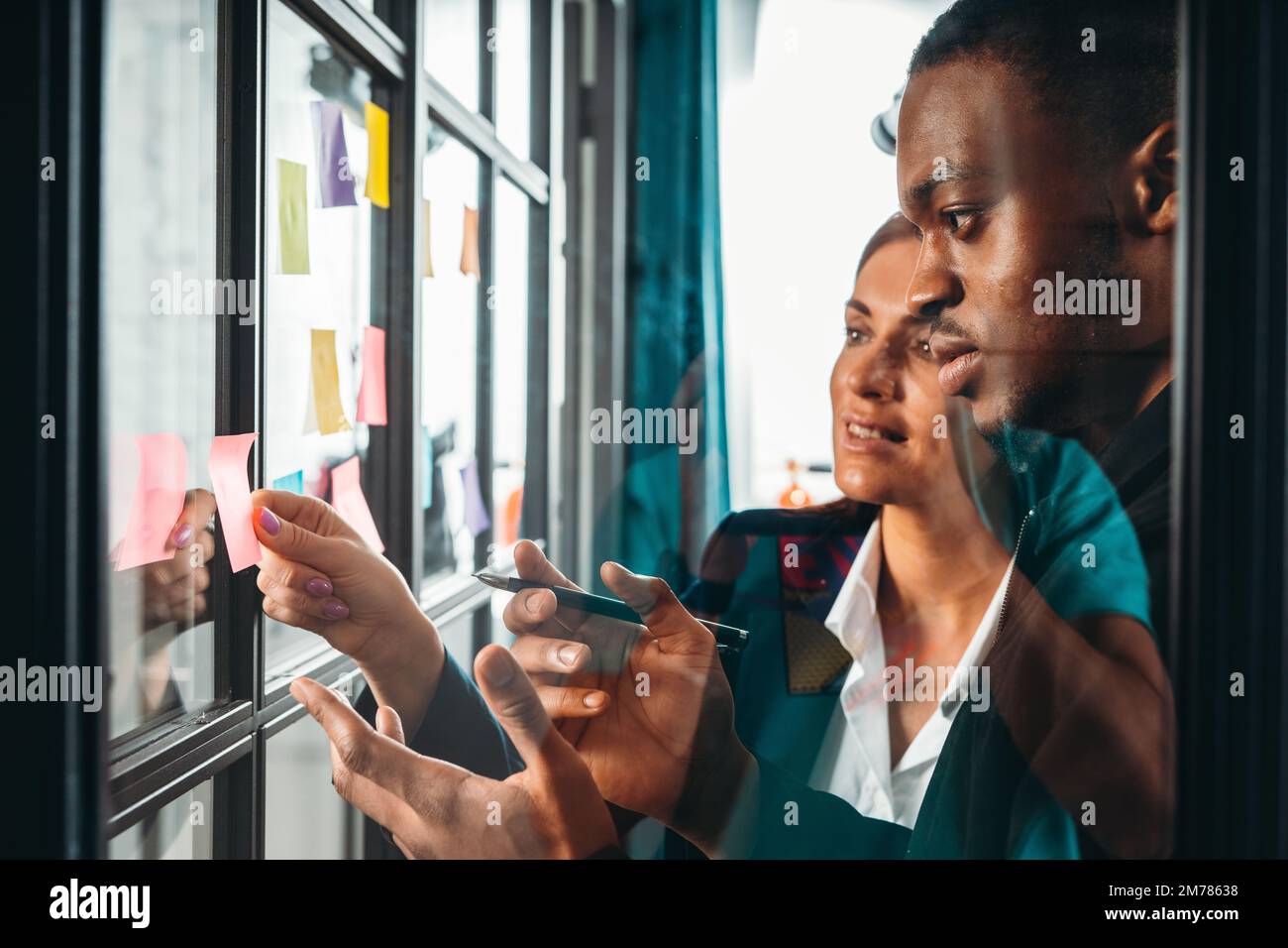 Business people in office work together analyzing data and graphs Stock Photo