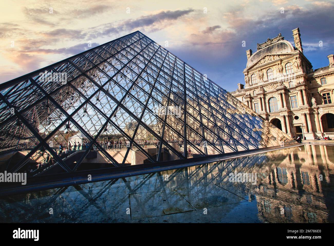 The center courtyard and dramatic pyramid entrance at the Louvre Museum in Paris, France. Stock Photo