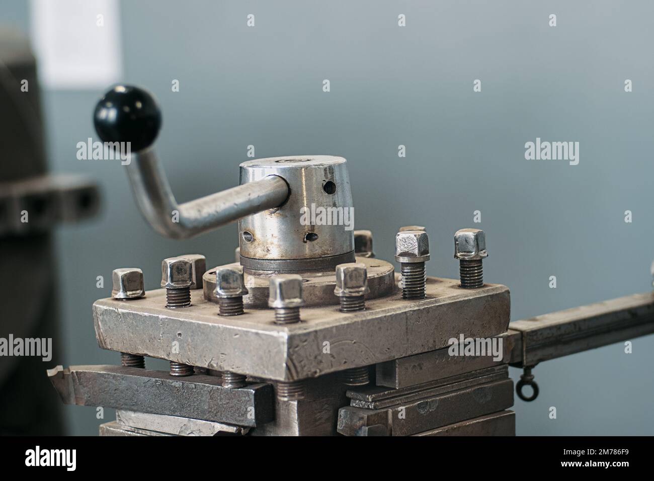 Old lathe for metal processing. Type of metal machine parts in lathe shop at factory. Industrial background. Industrial equipment.. Stock Photo
