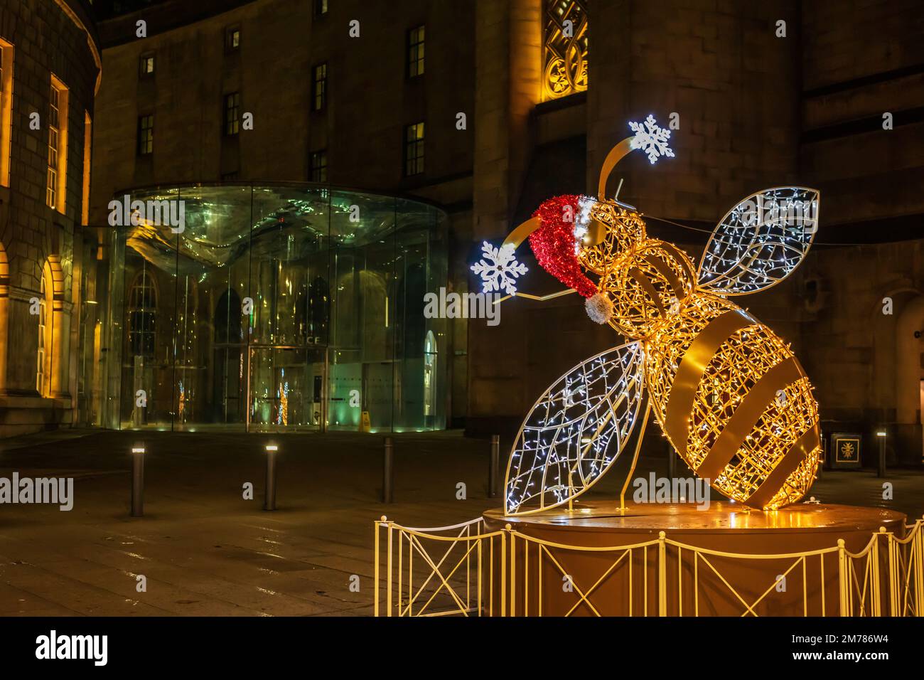Christmas street decoration illuminated sculpture of a bee, symbol of Manchester, UK. Stock Photo