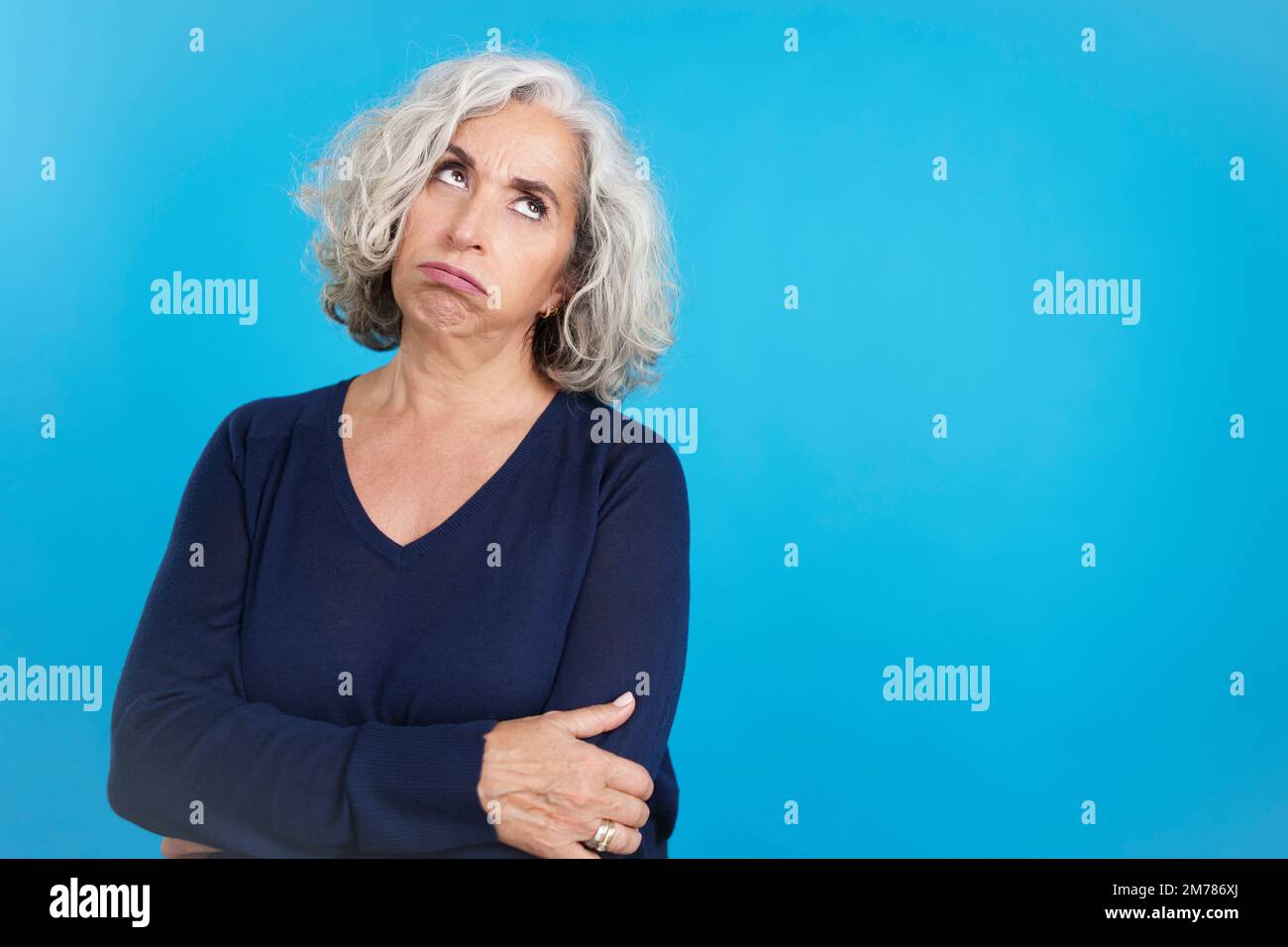Mature woman looking up with expression of boredom Stock Photo