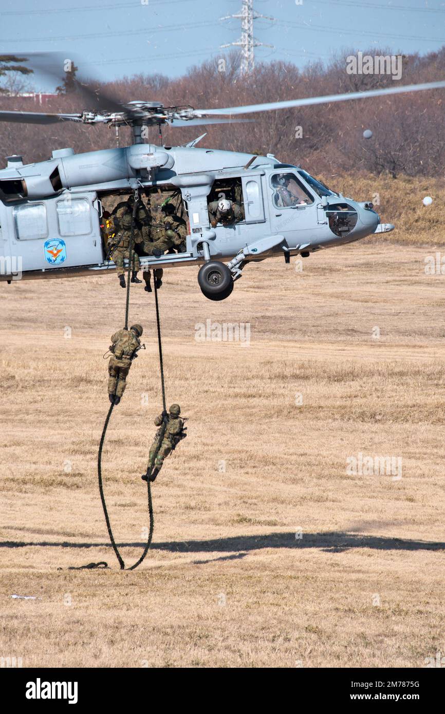 Narashino, Japan. 08th Jan, 2023. Member of Japan's Ground Self-Defense Force land on the drop zone from U.S. Navy's MH-60 during New year drill by the Japan's GSDF 1st Airborne Brigade at Narashino Training Area in Chiba-Prefecture, Japan on Sunday, January 8, 2023. Photo by Keizo Mori/UPI Credit: UPI/Alamy Live News Stock Photo
