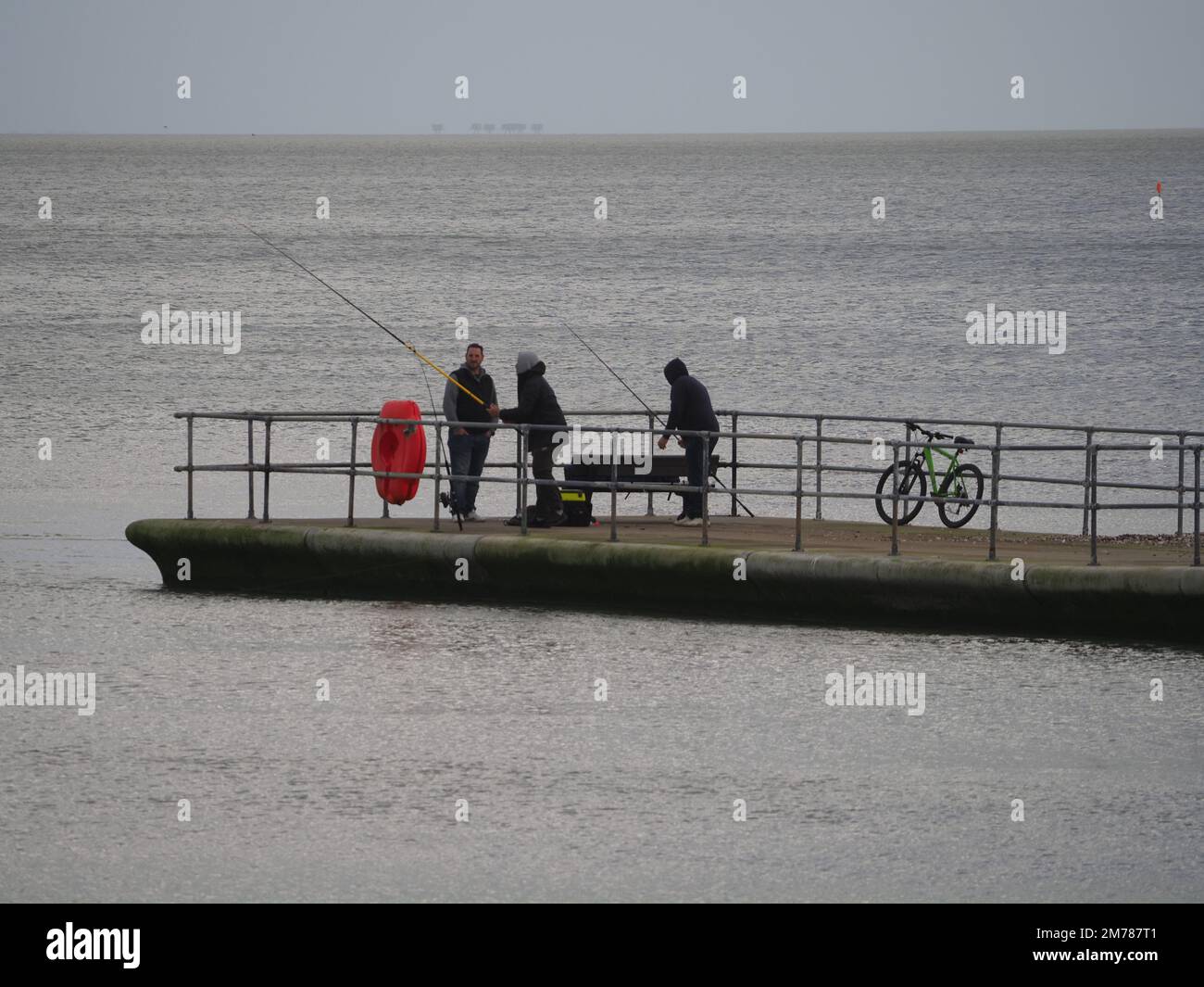 Sheerness, Kent, UK. 8th Jan, 2023. UK Weather: an overcast and windy afternoon Sheerness, Kent. People fish from Neptune Jetty. Credit: James Bell/Alamy Live News Stock Photo