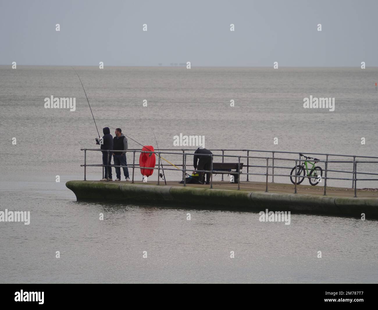 Sheerness, Kent, UK. 8th Jan, 2023. UK Weather: an overcast and windy afternoon Sheerness, Kent. People fish from Neptune Jetty. Credit: James Bell/Alamy Live News Stock Photo