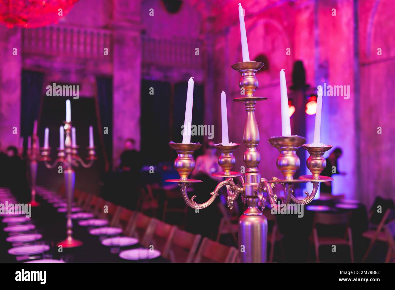 Vintage retro brass candlesticks with candles burning, luxury event