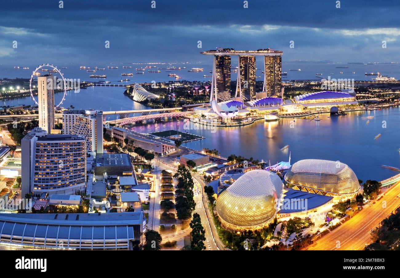 Aerial view of Singapore business district and city at twilight in ...