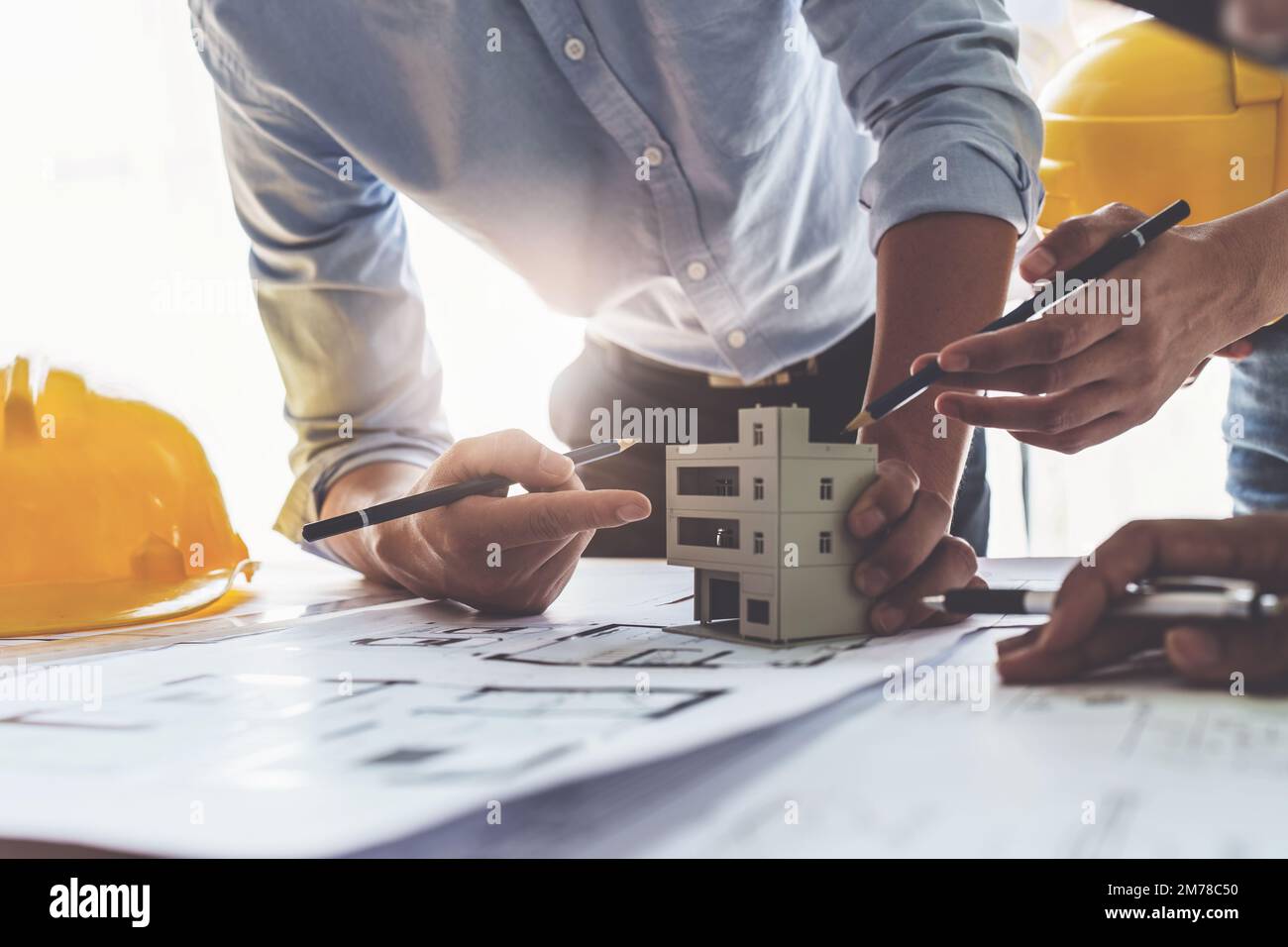 Architect team working with blueprints for architectural plan, engineer ...