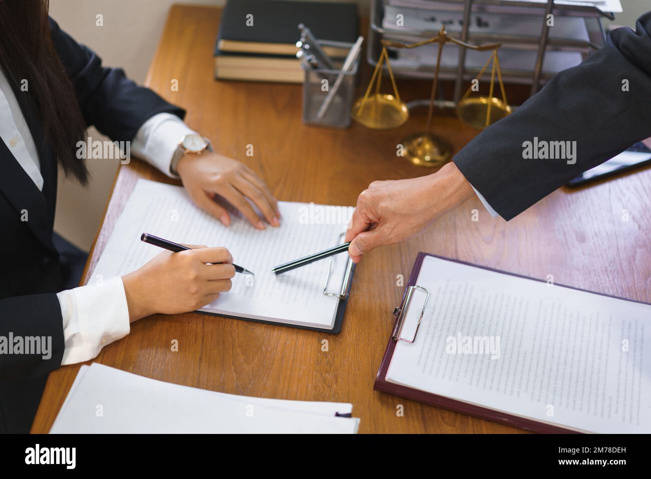 Legal and justice concept, Senior lawyer points on contract to provide ...