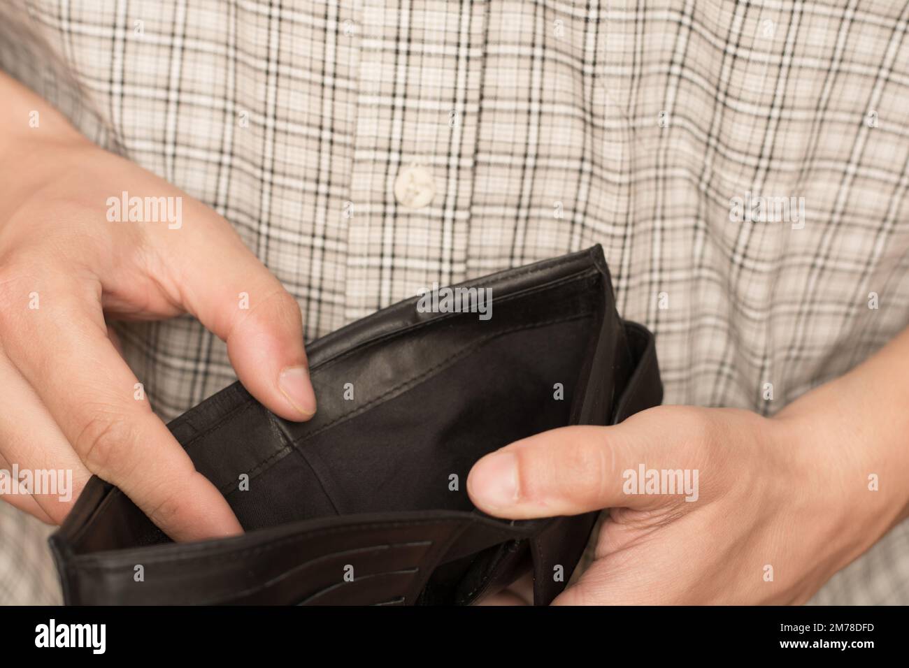 Close up of man hands holding and empty wallet Stock Photo