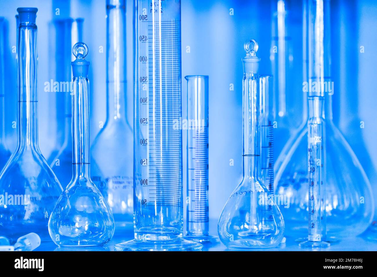 Clean empty flasks and test tubes closeup. Abstract background