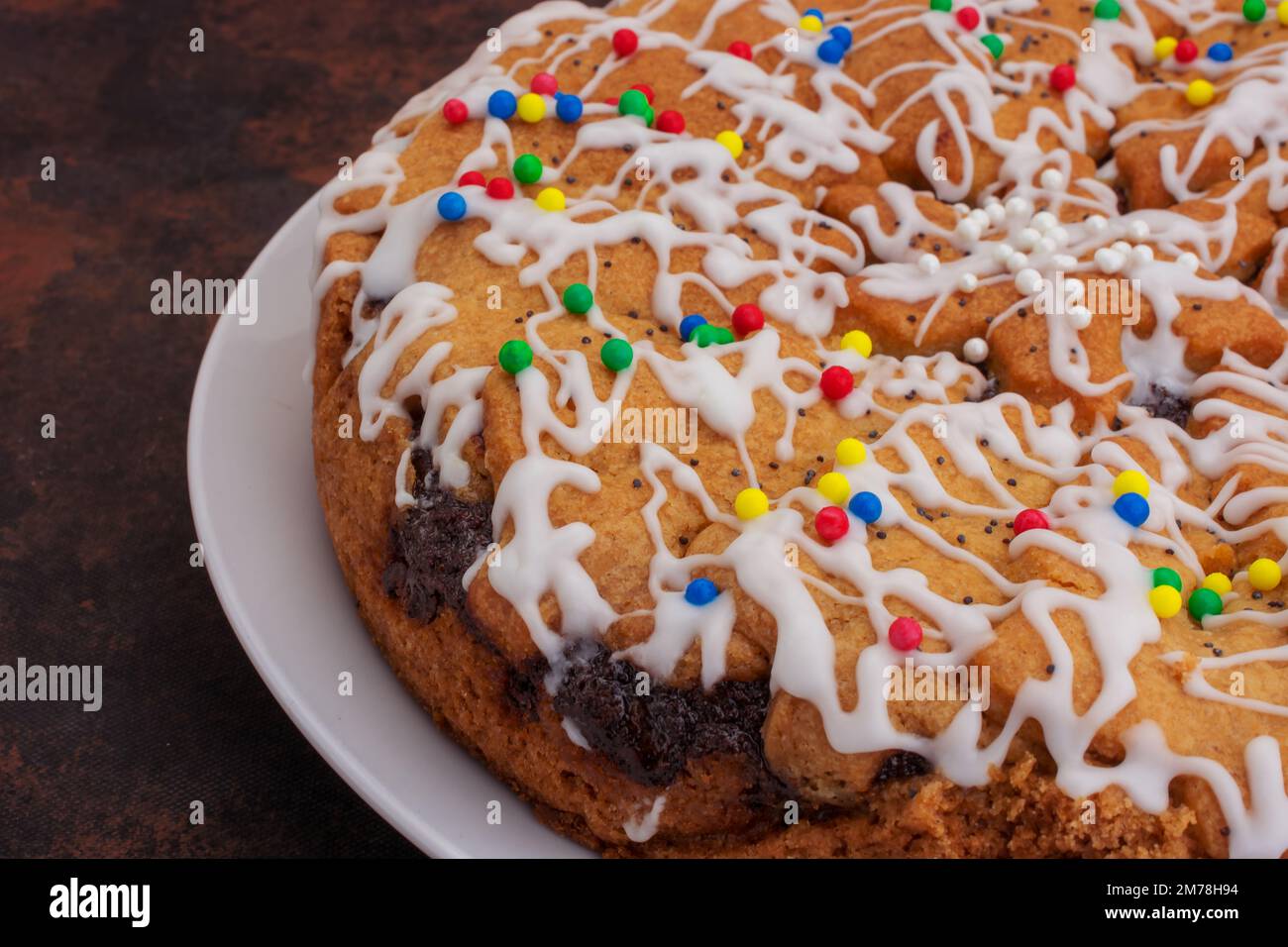 Appetizing poppy cake with icing sugar and lemon topping Stock Photo ...